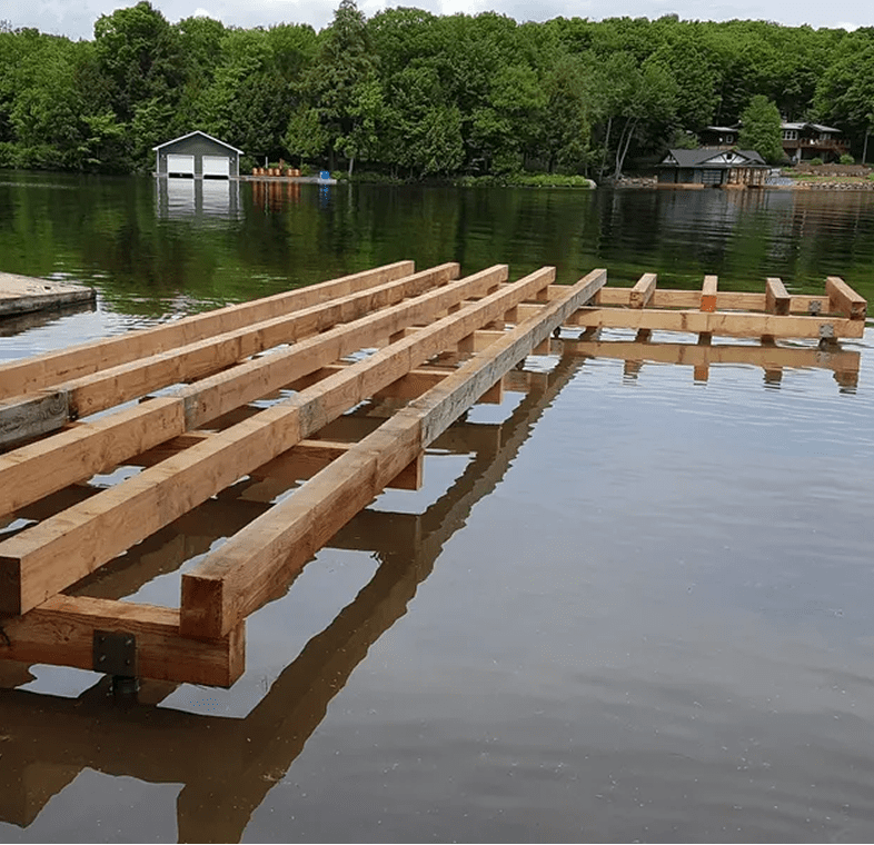 Wooden dock under construction by lake