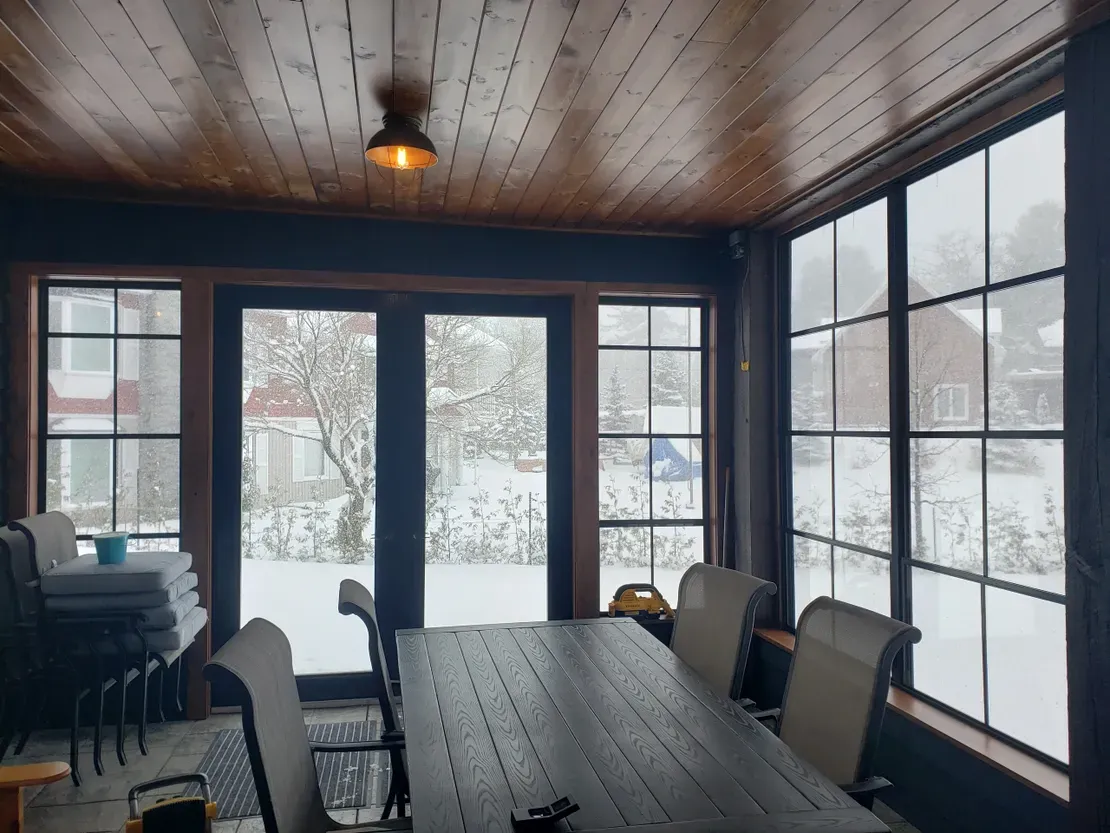 Snowy view from a cozy sunroom