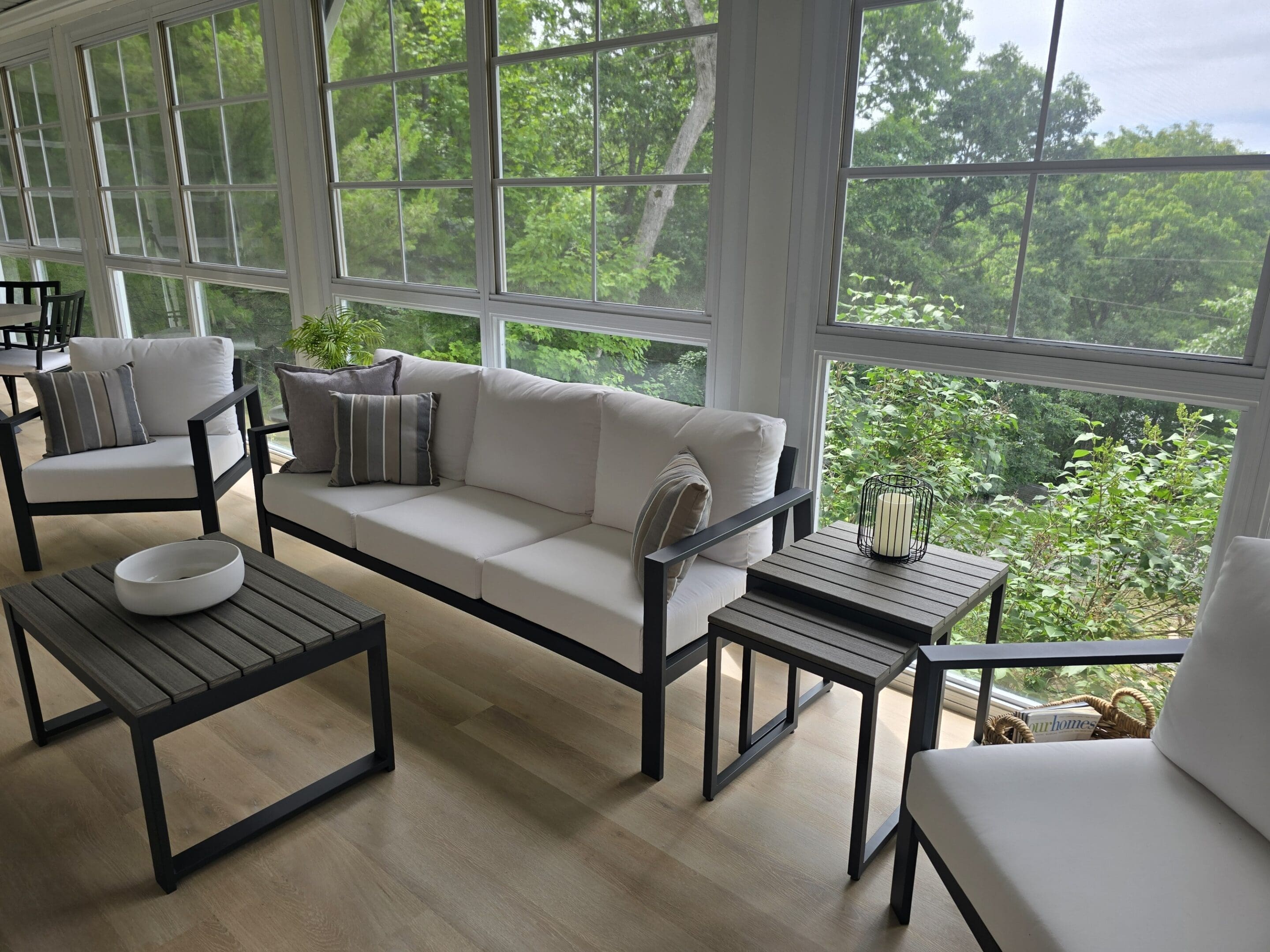 Sunroom with white cushioned sofa and view