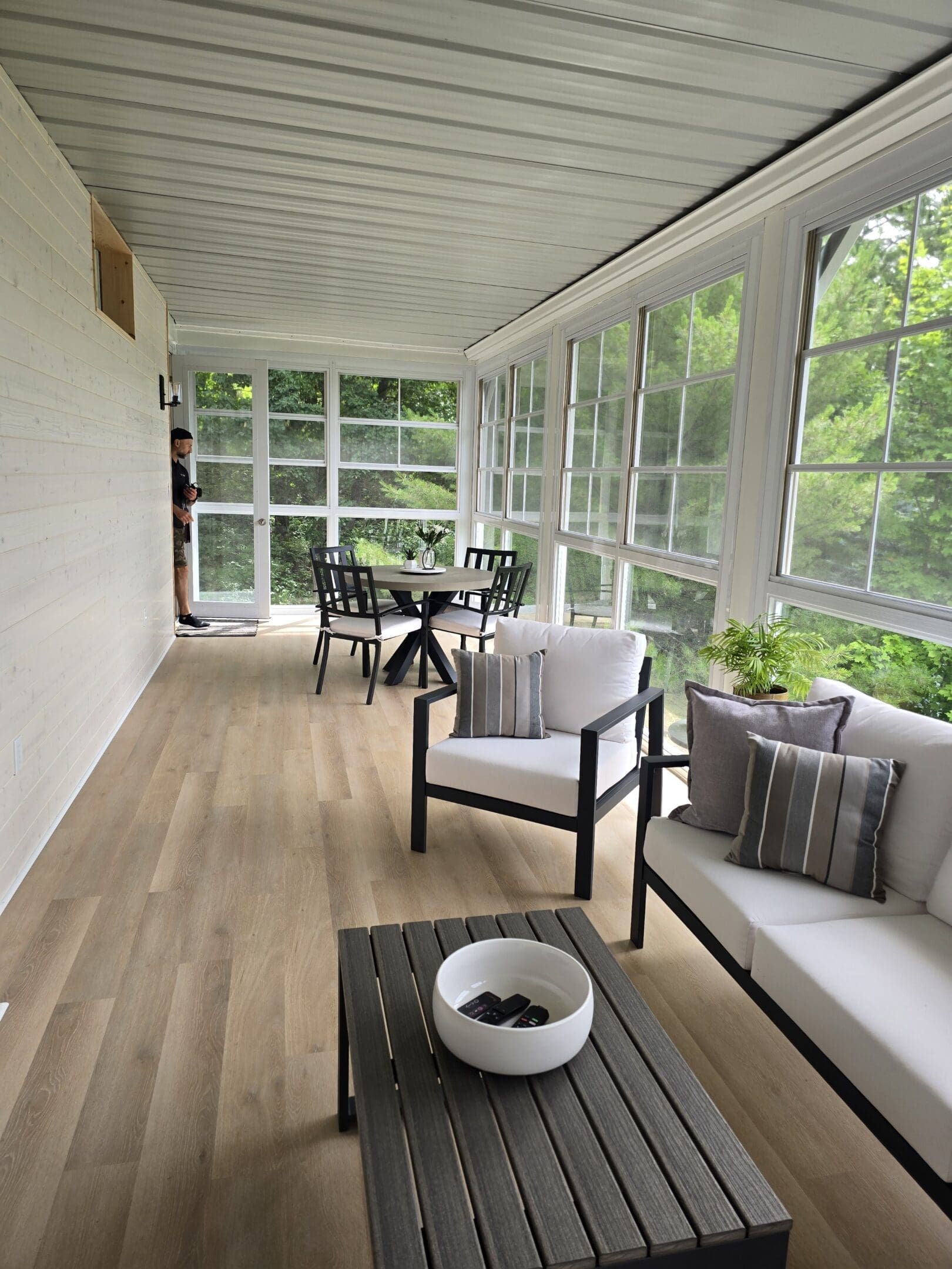 Bright sunroom with modern seating and table