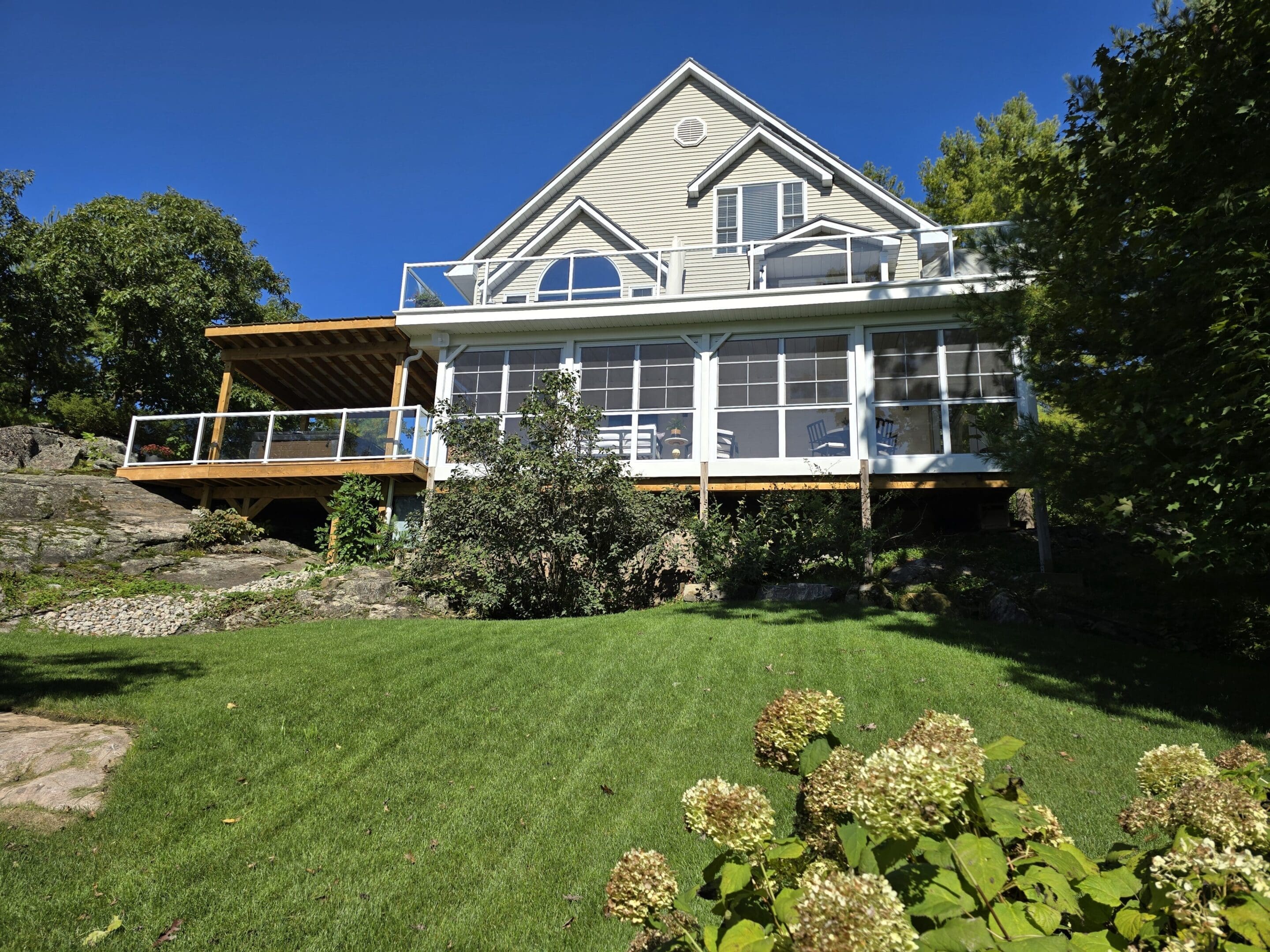 Large modern house with deck and lawn